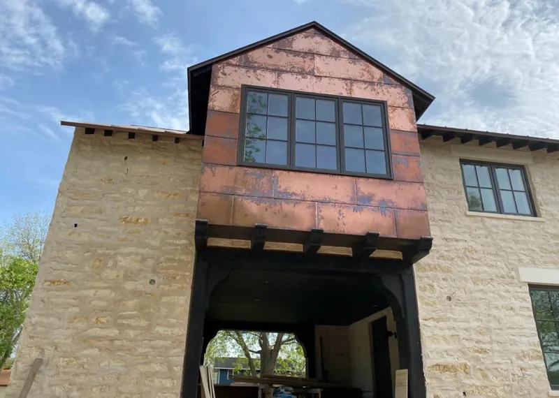 Copper metal panel facade on a stone building for Skylight Installation in Edison