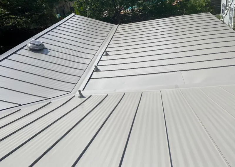 Solar attic fan installed on a metal roof for Roof Ventilation in Edison